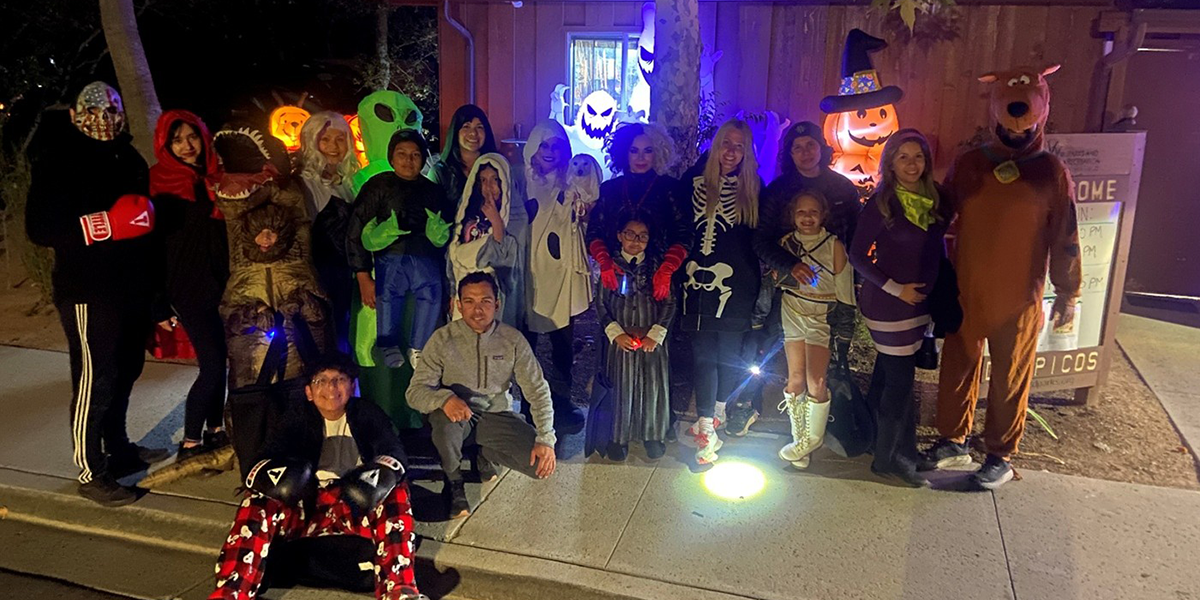 Dos Picos Halloween Festival - Group gathers for photo at night